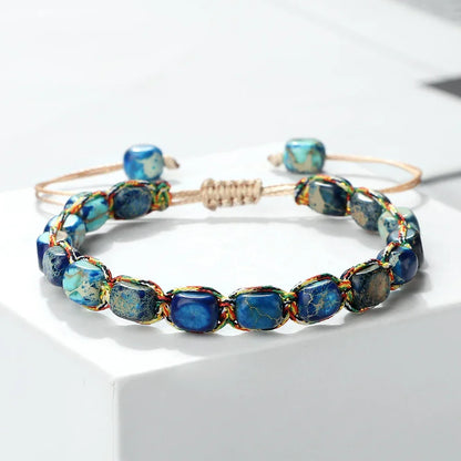 Handmade blue gemstone beaded adjustable bracelet with multicolor thread on white background